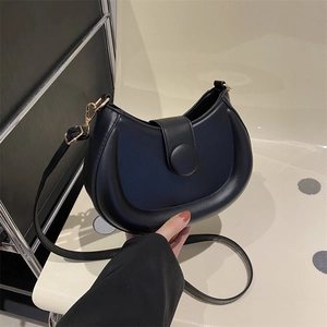 Chic black half-moon shoulder bag in soft faux leather with golden metal hardware detail