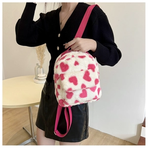 Detail of pink heart-patterned plush mini backpack with adjustable nylon straps