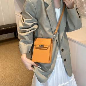 Chic orange leather mini crossbody phone bag with silver twist lock and slim strap
