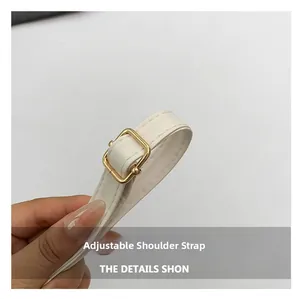 Detail of white PU leather adjustable shoulder strap with golden metal square buckle