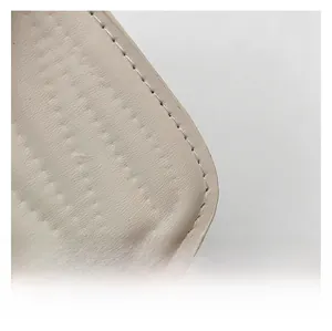 Close-up of cream white leather handbag showing soft lychee texture and neat stitching