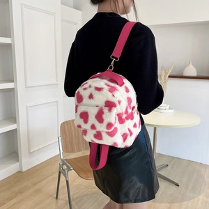 Cute white plush backpack with pink heart print and adjustable woven straps for women