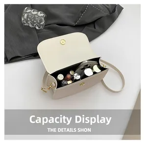Detail view of the beige crossbody bag interior showing storage for phone and lipsticks