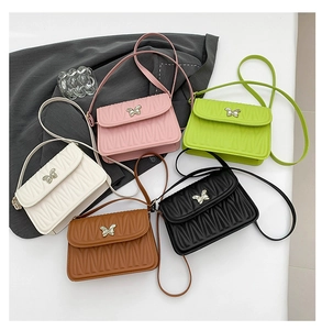 Five colored quilted mini shoulder bags with metal butterfly clasps shown in a group display