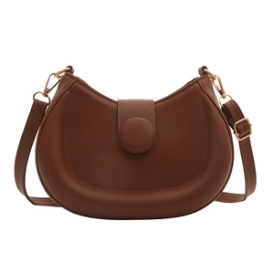Retro caramel brown leather half-moon shoulder bag with minimalist circular buckle