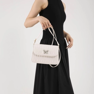 French style white wavy textured shoulder bag with a silver butterfly clasp for women