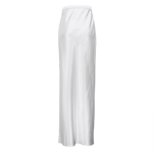 Detail of white satin maxi skirt showing elastic waist and smooth silky fabric texture