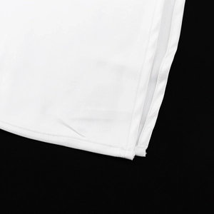 Macro view of white satin skirt featuring a side slit and clean double-needle stitching