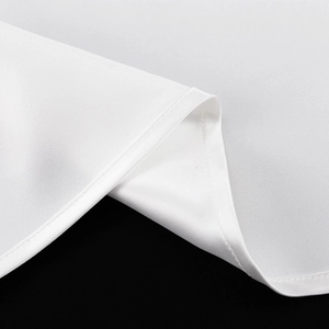 Detailed close-up showing high-quality hem stitching on a white satin long skirt