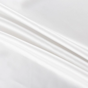 Detailed view of high-quality white satin fabric with smooth texture and elegant drape