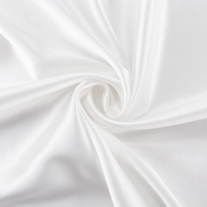 Detail of silky white satin fabric with elegant drape and smooth glossy texture