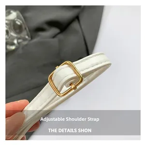 Close-up of adjustable white litchi pattern leather shoulder strap with gold buckle