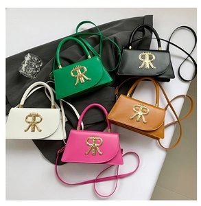 Detail showing five colors of leather crossbody bags with golden R metal hardware