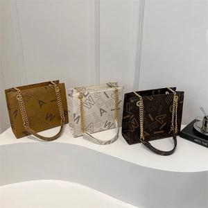 Three elegant tote bags in brown, beige, and dark coffee with metal chain straps