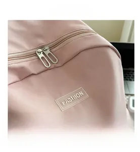 Close-up of pink toddler backpack showing metal zippers and a Fashion rubber logo