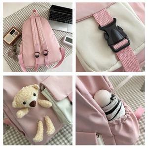 Pink canvas backpack detail view featuring adjustable straps and a cute plush bear charm