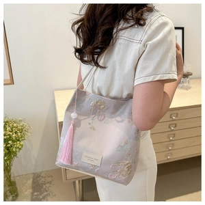 Detail of light purple tote bag with premium 3D floral embroidery and pink silk tassels