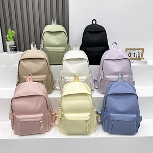 Minimalist waterproof school backpacks in multiple pastel colors with multi-pocket design