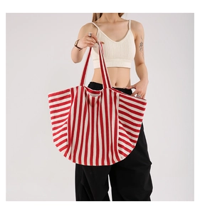 Detail of red and white striped canvas tote bag showing high-density fabric texture