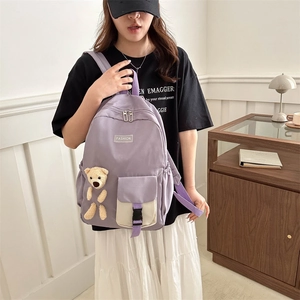 Lightweight lavender nylon girl school backpack with contrast pocket and bear charm