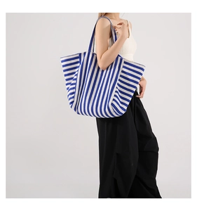 Detailed macro view of the durable blue and white striped fabric texture on a tote bag