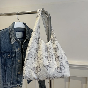 Floral butterfly jacquard hobo bag with soft textured fabric shown in lifestyle setting