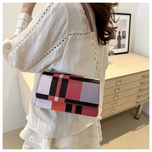 Detail of the colorful geometric grid leather shoulder bag with gold chain strap