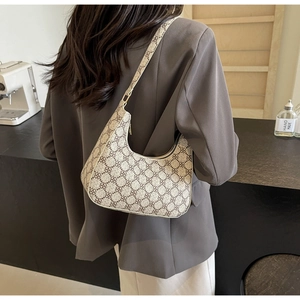 Detail view of vintage crescent shoulder bag with brown clover monogram pattern