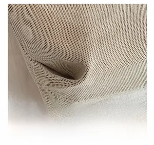 Close-up of precise stitching and beige honeycomb woven texture on a casual canvas tote bag