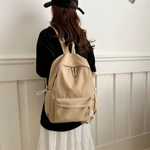 Minimalist khaki waterproof nylon backpack with large capacity and drawstring side pockets