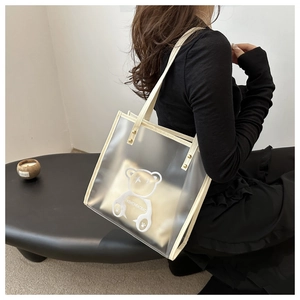 Detail of transparent PVC tote bag with bear print and inner pouch for extra privacy