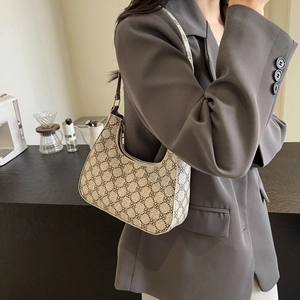 Retro patterned half-moon hobo bag in beige and brown with adjustable shoulder strap