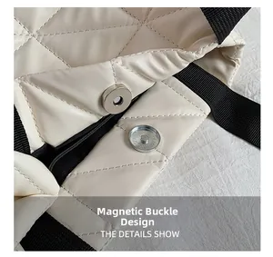 Close-up of cream quilted tote bag featuring a secure magnetic closure and leather texture
