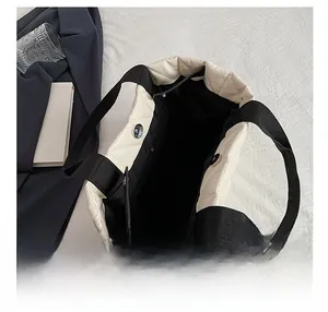 Top view of cream quilted tote bag showing internal black lining and magnetic snap closure