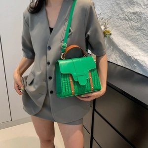 Green faux crocodile pattern shoulder bag with a brown handle and gold hardware detail