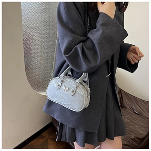 Silver metallic bowling bag featuring a vintage bow detail and elegant chain strap