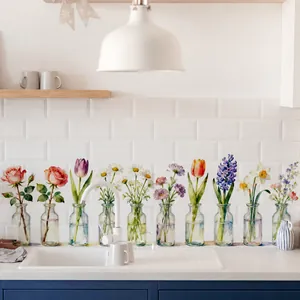 Detail of watercolor floral wall decals in glass bottles on white kitchen tile wall