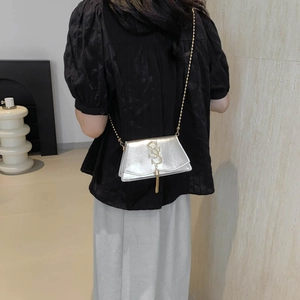 Silver chain crossbody envelope bag with gold S-logo and tassel detail for women