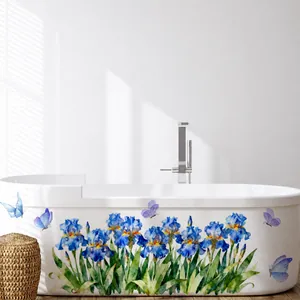 Self-adhesive blue iris flower and butterfly wall stickers on a white bathtub surface