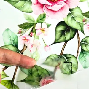 Detail showing self-adhesive backing of pink flower wall stickers for easy removal