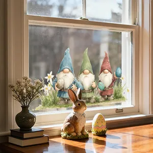 Close-up of three festive Easter gnomes window stickers with colorful eggs and flowers