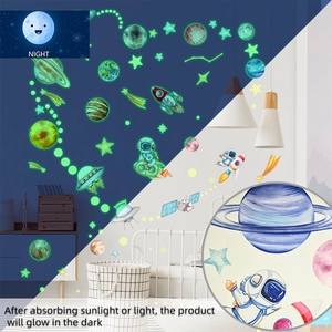 Luminous space wall decals showing daytime colors and glowing green rocket at night