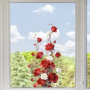 Close-up of watercolor rose and heart static window clings on glass with a sky background