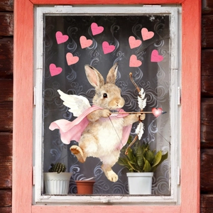 Detail of pink heart and rabbit cupid static window stickers on a glass surface