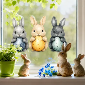 Close-up of Easter bunny window stickers with watercolor eggs on a sunny glass surface
