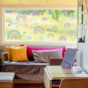 Close-up of rainbow and star static window clings applied to home glass door decor