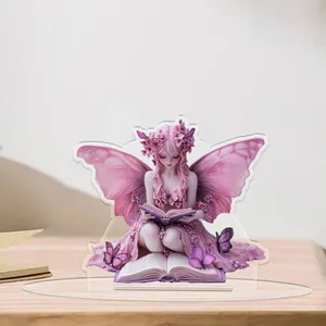 Detailed 2D acrylic pink fairy figurine reading a book on a wooden home desk