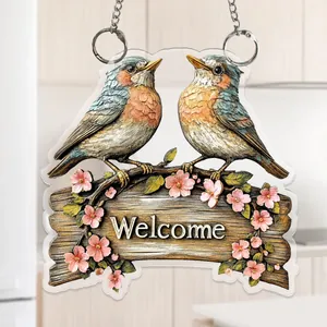 Detailed macro view of 2D flat acrylic welcome sign featuring two birds and pink flowers