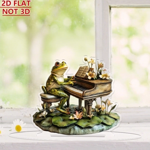 Detailed macro view of 2D flat acrylic frog playing piano ornament on a white windowsill