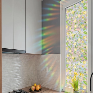 Rainbow prism window film detail showing yellow rose pattern and sunlight refraction